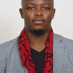 Home face of young handsome bald african businessman in suit